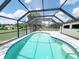 Enclosed pool provides a refreshing oasis with bright blue water and a clear view of the yard at 3456 Highlands Rd, Punta Gorda, FL 33983
