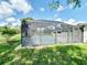 Outdoor pool with screen enclosure offers a view of the lawn and privacy from the neighbors at 3456 Highlands Rd, Punta Gorda, FL 33983