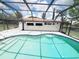 Screened-in pool area with sparkling water and a blue trim offers outdoor enjoyment and relaxation at 3456 Highlands Rd, Punta Gorda, FL 33983