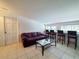 Open living area features tile floors, a leather sofa, wet bar, and four chairs at a counter at 3456 Highlands Rd, Punta Gorda, FL 33983