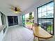 Bright sun room featuring tile flooring, backyard access, and canal views at 3456 Highlands Rd, Punta Gorda, FL 33983