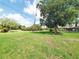 Spacious and well-maintained front yard with mature trees, offering ample space for outdoor activities and landscaping at 3456 Highlands Rd, Punta Gorda, FL 33983