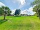 Lush lawn, framed by mature trees offers plenty of space for recreation and the potential for your landscaping dreams at 3456 Highlands Rd, Punta Gorda, FL 33983