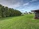 Large backyard with privacy landscaping, green grass and an enclosed patio at 3512 Nekoosa St, North Port, FL 34287