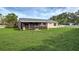 Large backyard featuring a screened-in porch area and lush green grass at 3512 Nekoosa St, North Port, FL 34287