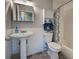 Cozy bathroom featuring a pedestal sink, a shower with a patterned curtain, and a medicine cabinet at 3512 Nekoosa St, North Port, FL 34287