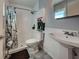 Bathroom featuring a shower with decorative shower curtain and sink with white cabinets at 3512 Nekoosa St, North Port, FL 34287
