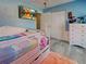 Colorful bedroom with a toddler bed, adjacent closet, and a mounted TV at 3512 Nekoosa St, North Port, FL 34287