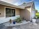 Home exterior featuring neutral paint, updated windows, decorative rock and fresh plantings at 3512 Nekoosa St, North Port, FL 34287