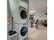 Convenient laundry area featuring stacked washer and dryer units leading into the living room at 3512 Nekoosa St, North Port, FL 34287