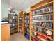 Library with built-in, wood-paneled bookshelves filled with reading materials and other items at 3512 Nekoosa St, North Port, FL 34287