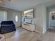 Inviting living room featuring a large television, hardwood floors, and a bright entryway at 3512 Nekoosa St, North Port, FL 34287