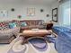 Inviting living room with a large sofa, area rug, hardwood floors, and natural light at 3512 Nekoosa St, North Port, FL 34287