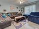 Cozy living room with a large sofa, hardwood floors, and plenty of natural light at 3512 Nekoosa St, North Port, FL 34287
