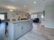 Open floor plan with large island and chairs leading into a comfortable living room at 3512 Nekoosa St, North Port, FL 34287
