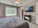 Serene main bedroom with gray walls, wood flooring, and a mounted television at 3512 Nekoosa St, North Port, FL 34287