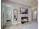 Bedroom featuring a television, a decorative mirror, and an ensuite bathroom at 3512 Nekoosa St, North Port, FL 34287