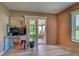 Office space with sliding glass doors to the screened in porch and laminate wood flooring at 3512 Nekoosa St, North Port, FL 34287