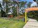 Scenic view of the Boundless Adventures playground with colorful equipment and surrounding trees, ideal for recreation at 3512 Nekoosa St, North Port, FL 34287