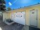 Outside showers and bathrooms by a pool area, constructed of yellow siding with white doors and black hardware at 3512 Nekoosa St, North Port, FL 34287
