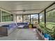 Screened patio featuring outdoor furniture, a ceiling fan, and several green plants at 3512 Nekoosa St, North Port, FL 34287