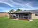 Enclosed patio with outdoor furniture, greenery, and view of the backyard at 3512 Nekoosa St, North Port, FL 34287