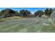 Community tennis court surrounded by a chain link fence at 3512 Nekoosa St, North Port, FL 34287
