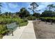 Scenic walking path featuring a bench, lush landscaping, and a tranquil environment for relaxation and enjoying nature at 3512 Nekoosa St, North Port, FL 34287