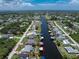 A waterfront property featuring a private dock with direct access to the Gulf, plus a pool and lush landscaping at 4051 Rock Creek Dr, Port Charlotte, FL 33948
