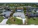 Aerial view of a single-Gathering home on a canal, featuring a well-manicured lawn at 4051 Rock Creek Dr, Port Charlotte, FL 33948