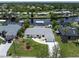 Waterfront home featuring a private dock with a boat lift, lush landscaping, and a well-maintained yard at 4051 Rock Creek Dr, Port Charlotte, FL 33948