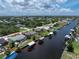 Aerial view showcases single-Gathering home on canal, with convenient access to neighborhood streets and nearby community at 4051 Rock Creek Dr, Port Charlotte, FL 33948