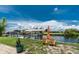 Lawn chairs sit on a landscaped lawn along a canal with boat dock at 4051 Rock Creek Dr, Port Charlotte, FL 33948