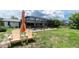 Two lawn chairs sit on a grassy lawn with a view of the pool and canal at 4051 Rock Creek Dr, Port Charlotte, FL 33948