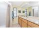 Well-lit bathroom features granite counters, wood cabinets, large mirror, and a walk-in shower at 4051 Rock Creek Dr, Port Charlotte, FL 33948