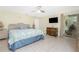 Comfortable bedroom featuring tiled floors, ceiling fan, and sliders to sunroom for ample sunlight at 4051 Rock Creek Dr, Port Charlotte, FL 33948
