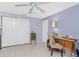 Cozy bedroom features tiled floors, a ceiling fan, and a functional desk area at 4051 Rock Creek Dr, Port Charlotte, FL 33948