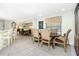 Dining area with tile flooring, large windows with natural light, and bar seating to the kitchen at 4051 Rock Creek Dr, Port Charlotte, FL 33948