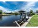 A boat is shown on a boat lift along a canal with a dock and sea wall at 4051 Rock Creek Dr, Port Charlotte, FL 33948