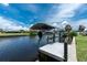 A boat is shown on a boat lift along the canal with a dock at 4051 Rock Creek Dr, Port Charlotte, FL 33948