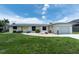 Charming single-story home with well-maintained lawn, and a bright yellow front door at 4051 Rock Creek Dr, Port Charlotte, FL 33948