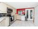 Well-equipped kitchen featuring stainless steel appliances, granite countertops, and tile flooring at 4051 Rock Creek Dr, Port Charlotte, FL 33948