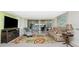 Bright living room with sliding glass doors to the pool and lanai, plus comfortable seating at 4051 Rock Creek Dr, Port Charlotte, FL 33948