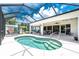 The screened-in lanai features a kidney shaped pool with stairs leading into the water at 4051 Rock Creek Dr, Port Charlotte, FL 33948