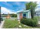 A shed is situated in a tropical backyard setting along the canal at 4051 Rock Creek Dr, Port Charlotte, FL 33948