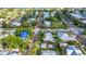 Neighborhood aerial view of a house with a pool, lush palms and brick roads near the bay at 415 W Marion Ave, Punta Gorda, FL 33950