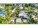 Aerial view of a home with a pool, complemented by tropical landscaping and a separate outbuilding at 415 W Marion Ave, Punta Gorda, FL 33950
