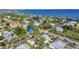 Community aerial view near the bay showcasing well-maintained homes, lush landscaping and brick-paved streets at 415 W Marion Ave, Punta Gorda, FL 33950