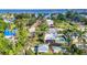 Aerial view of a house with a pool and lush greenery, near a brick road and the bay at 415 W Marion Ave, Punta Gorda, FL 33950