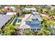 Aerial view of the property showcasing a pool, metal roof, and tropical landscaping at 415 W Marion Ave, Punta Gorda, FL 33950